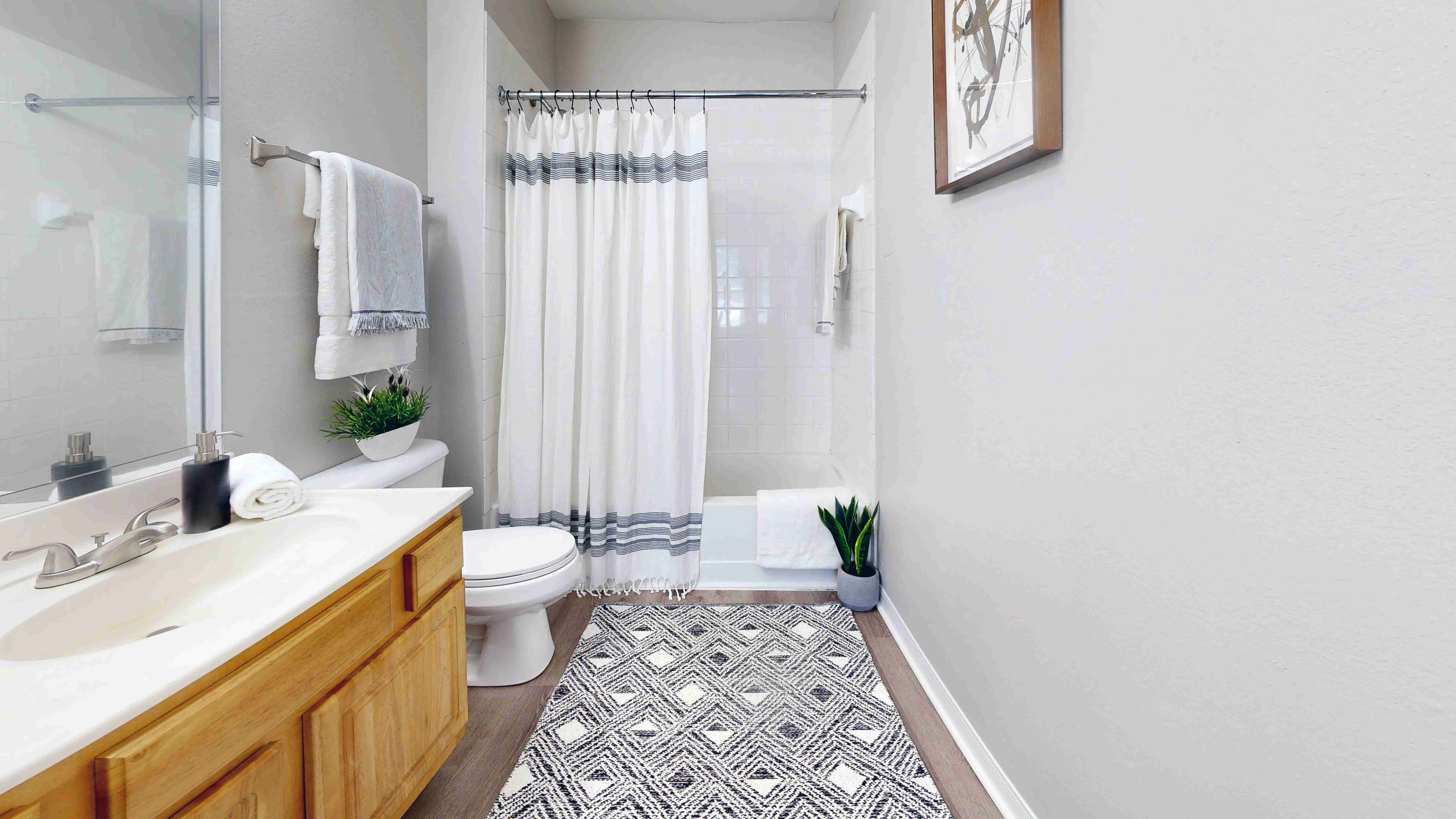 Featuring large mirrors and a tiled shower/tub combo, your bathroom is the perfect place to pamper yourself.