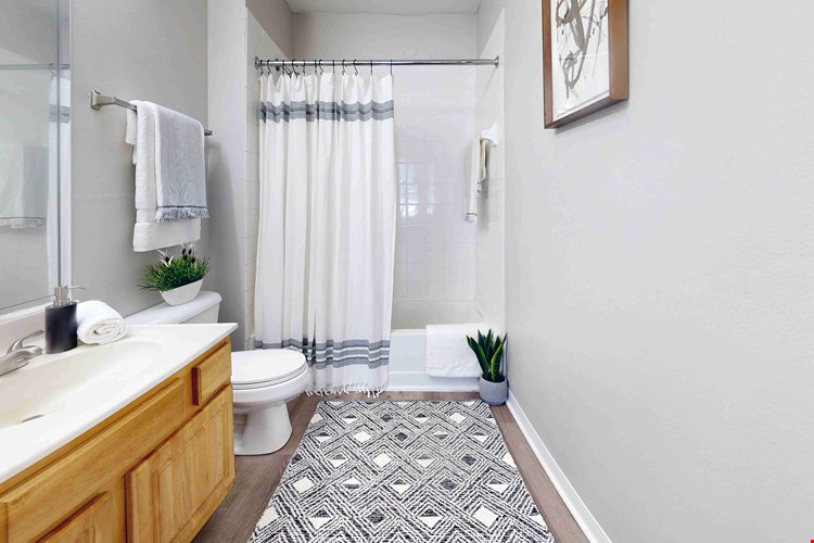 Featuring large mirrors and a tiled shower/tub combo, your bathroom is the perfect place to pamper yourself.
