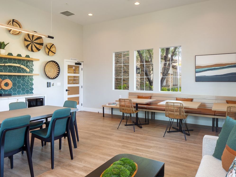 Resident lounge with entertaining kitchen, dining area, and lounge seating