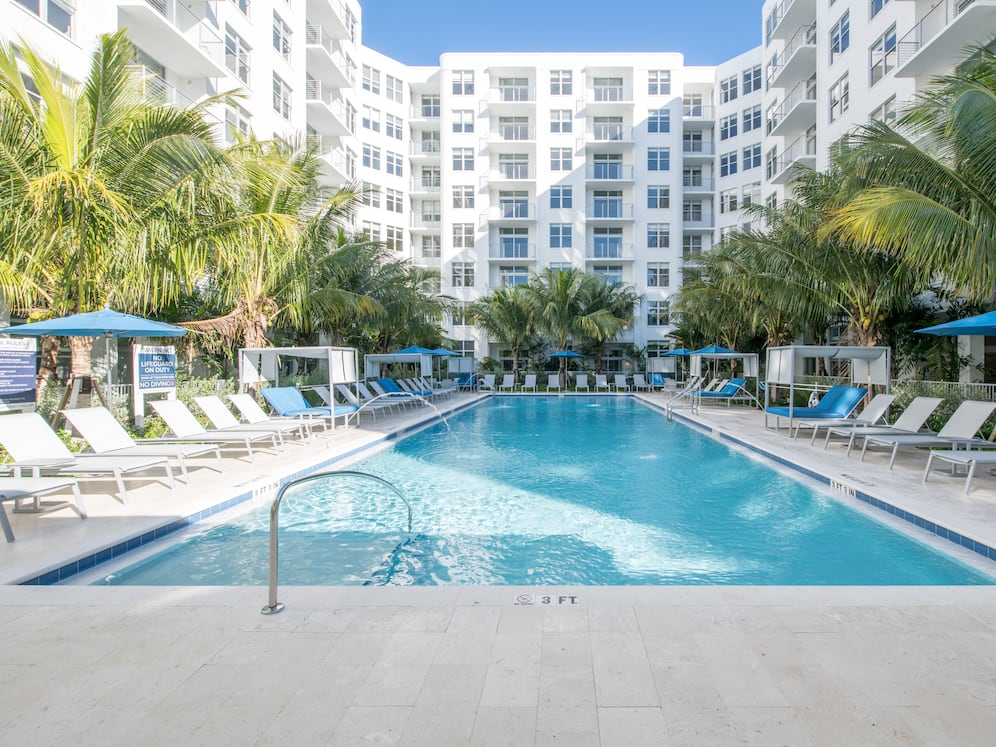 Swimming pool and sundeck with cabanas and lounge seating. Gazebo with flat screen TV.