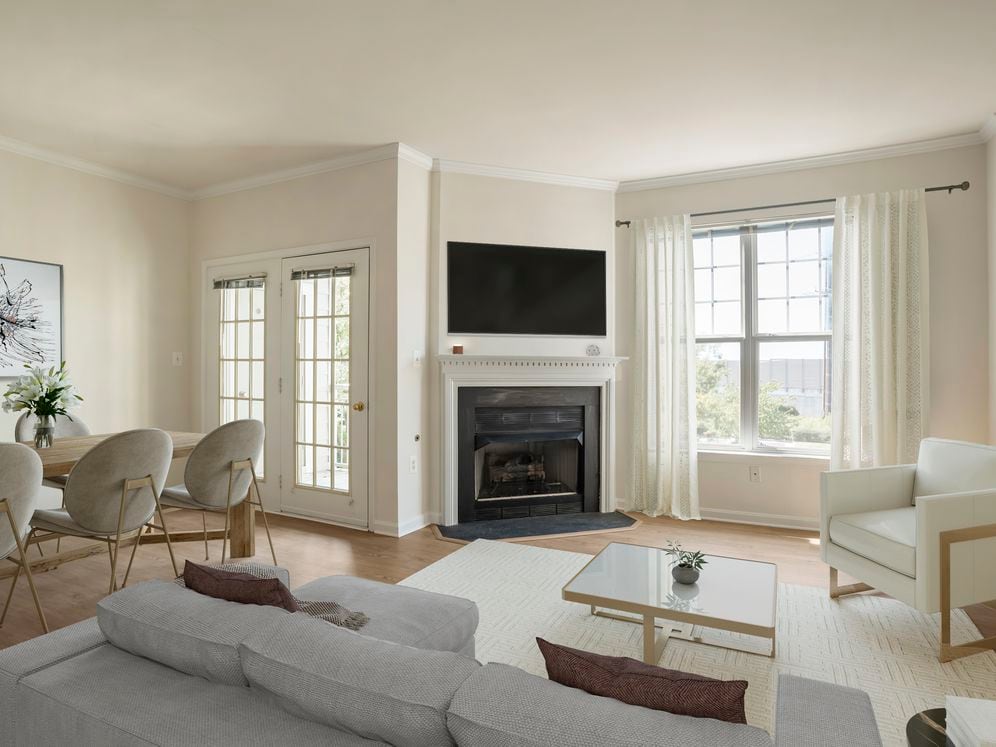 Renovated Package II living and dining area with fireplace and hard surface flooring