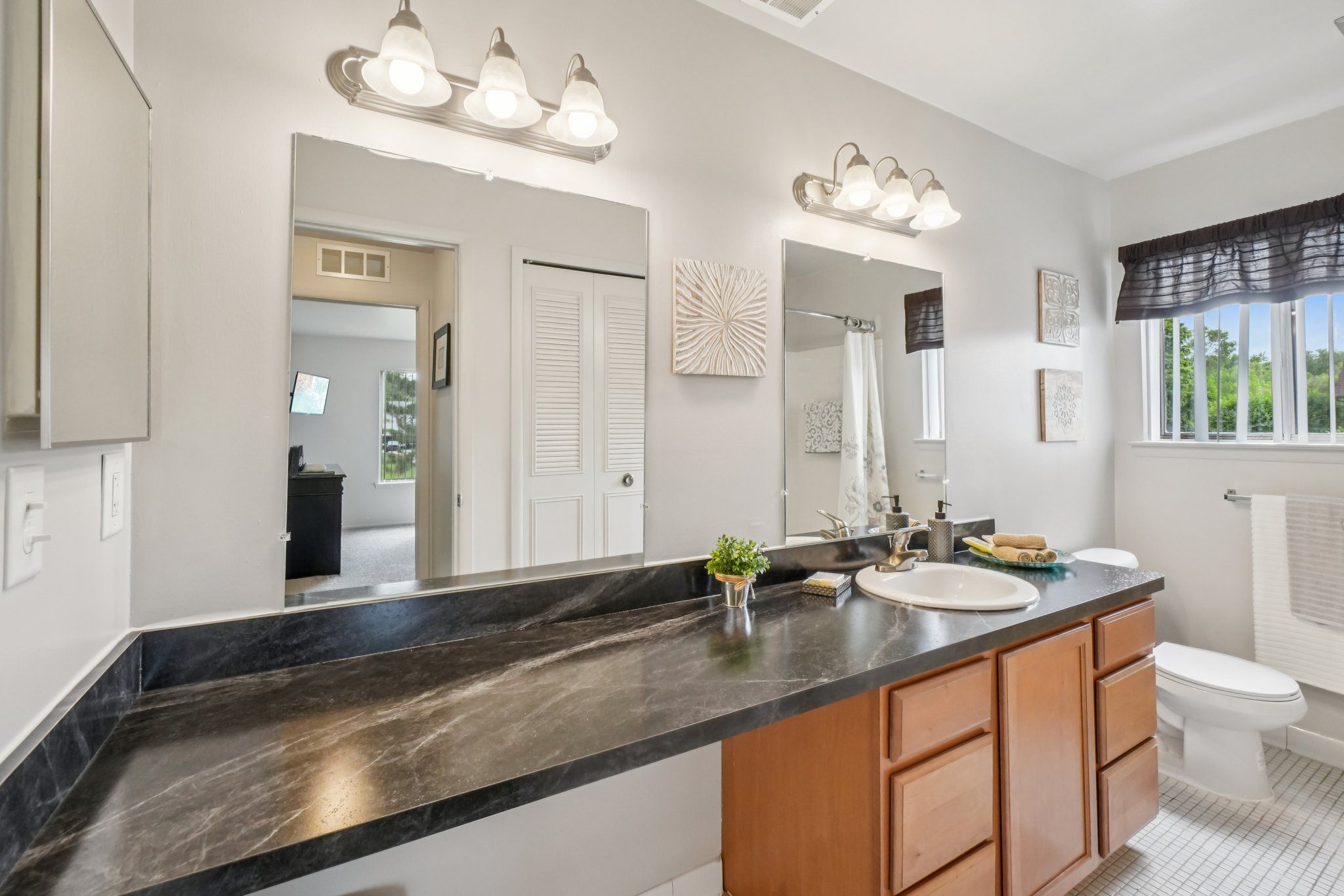 Spacious bathroom with ample storage at Drawbridge Apartments in Harrison Township, MI.