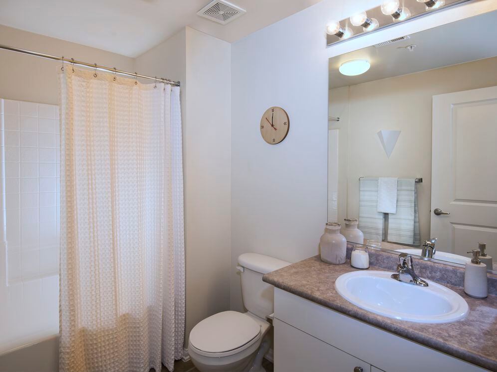 Classic Package I bath with white cabinetry, laminate countertops, and tile flooring