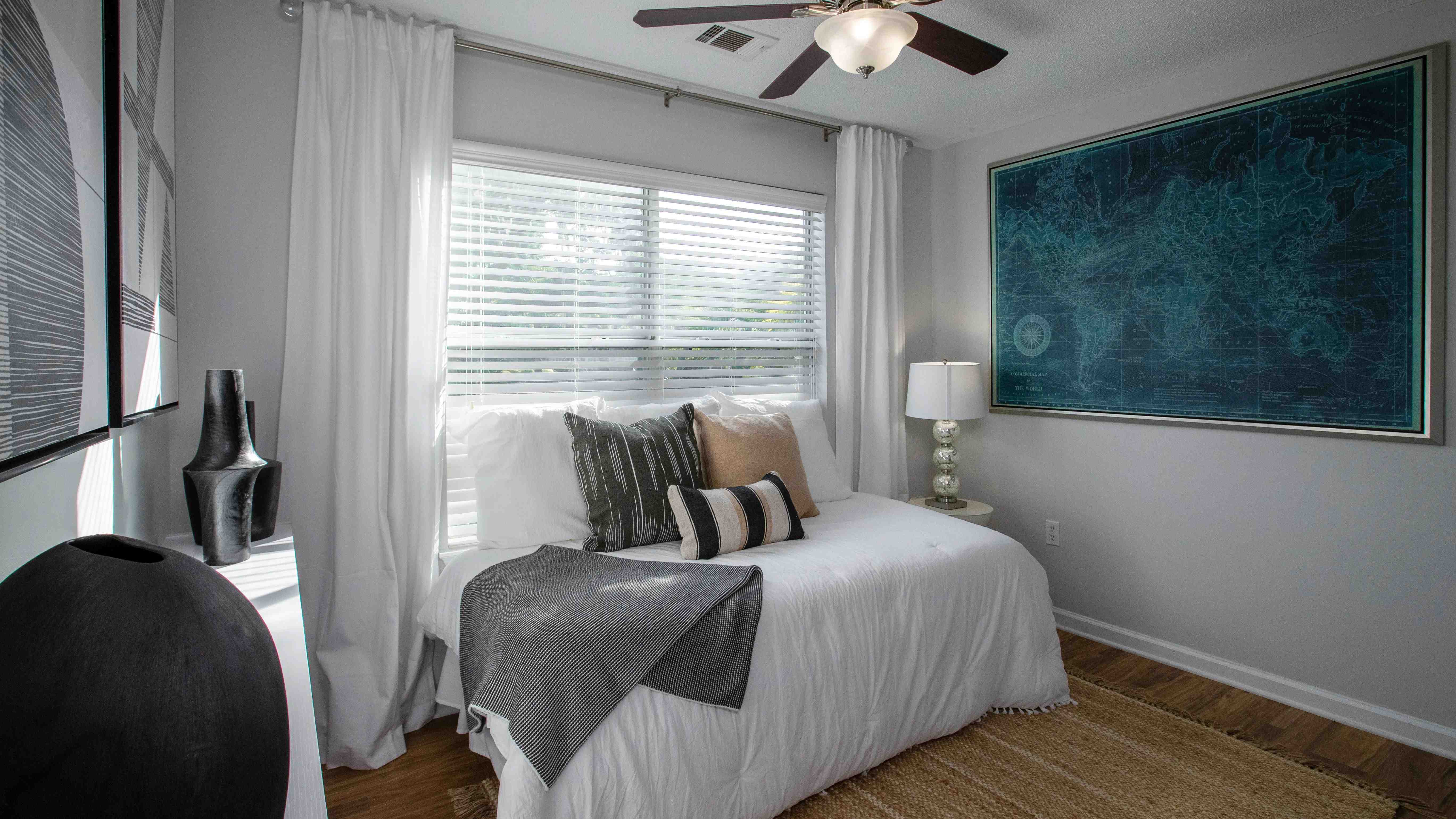 Wake up to the embrace of sunlight in this inviting bedroom at Emerson Isles.