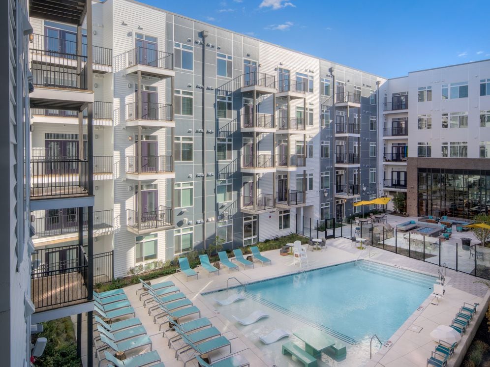 Courtyard with swimming pool, sundeck and lounge seating