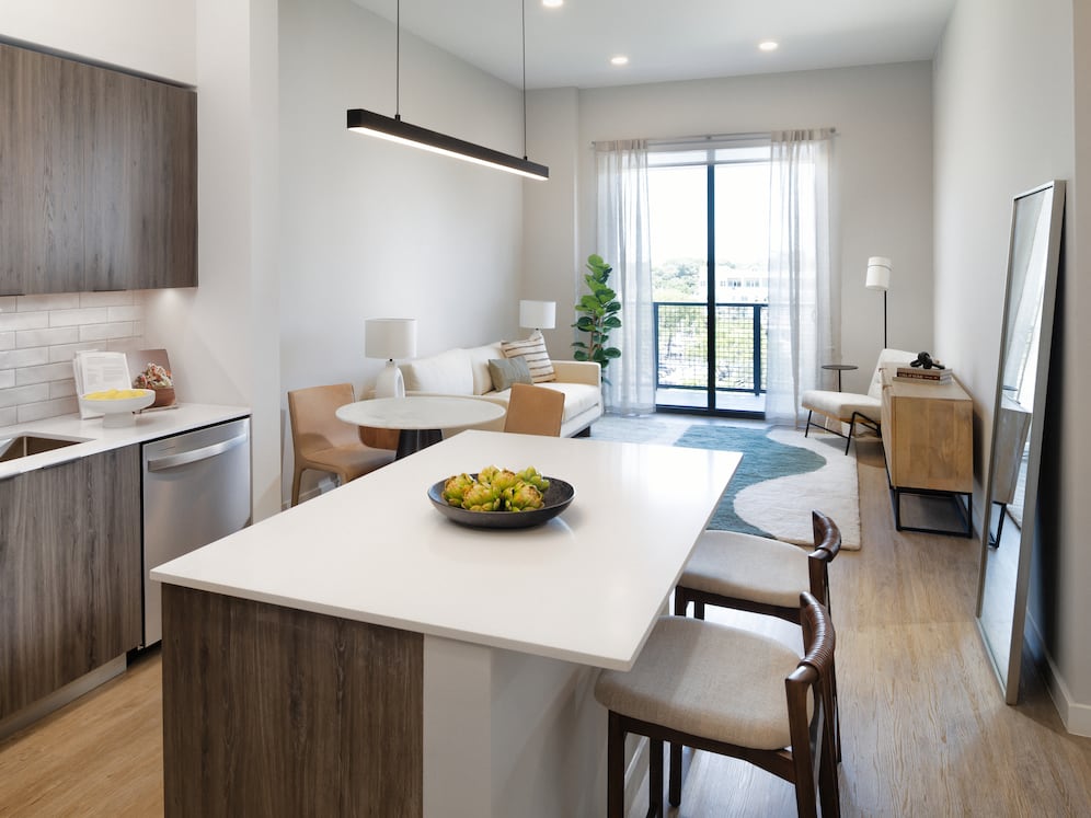 Upgrade Collection II kitchen with espresso cabinetry, white tile backsplash, stainless steel appliances, and hard-surface vinyl plank flooring