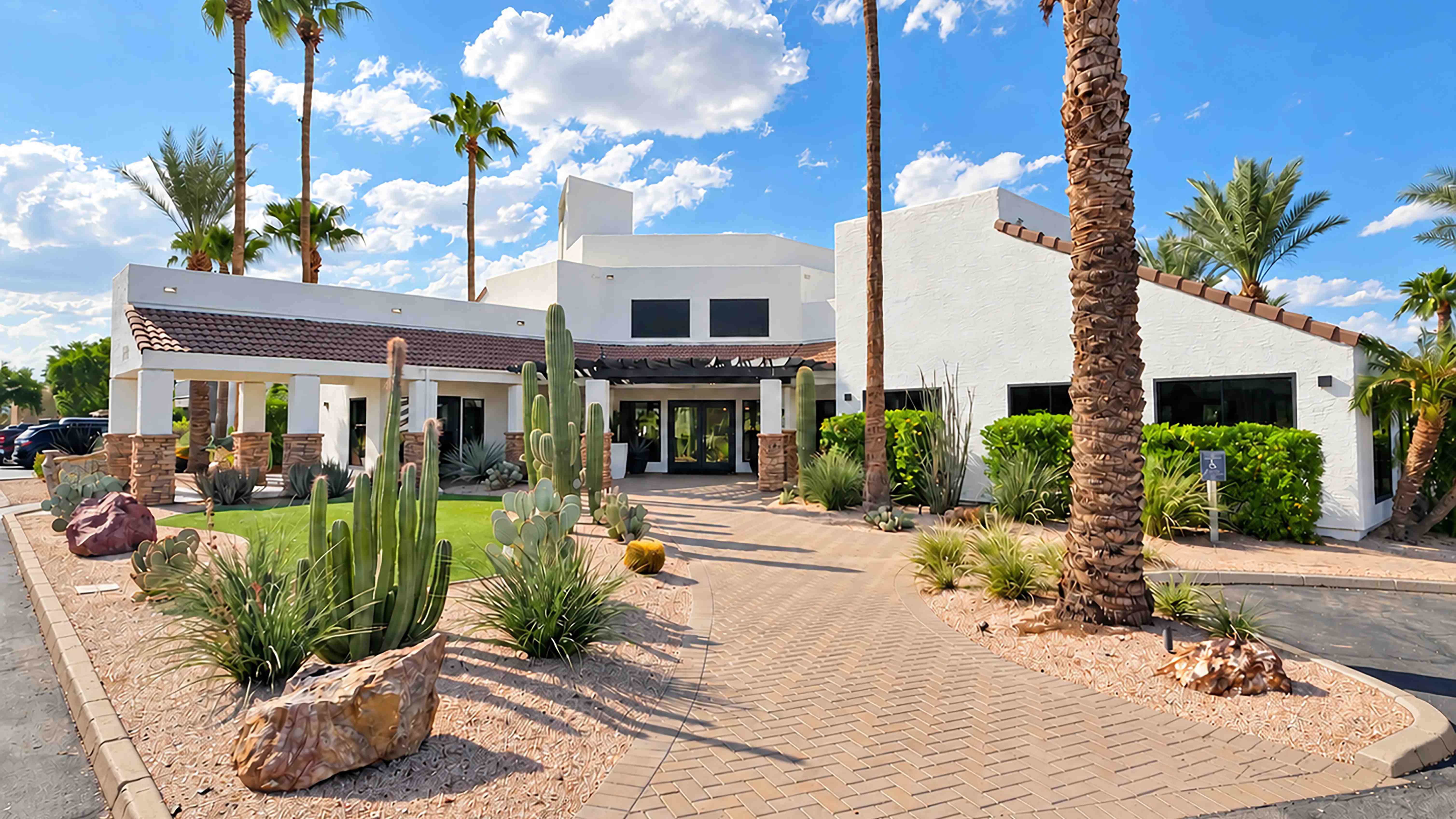 Step into the Level 550 experience at the leasing office, surrounded by towering palms, colorful blooms, and distinctive desert landscaping that reflects the community’s Arizona setting.