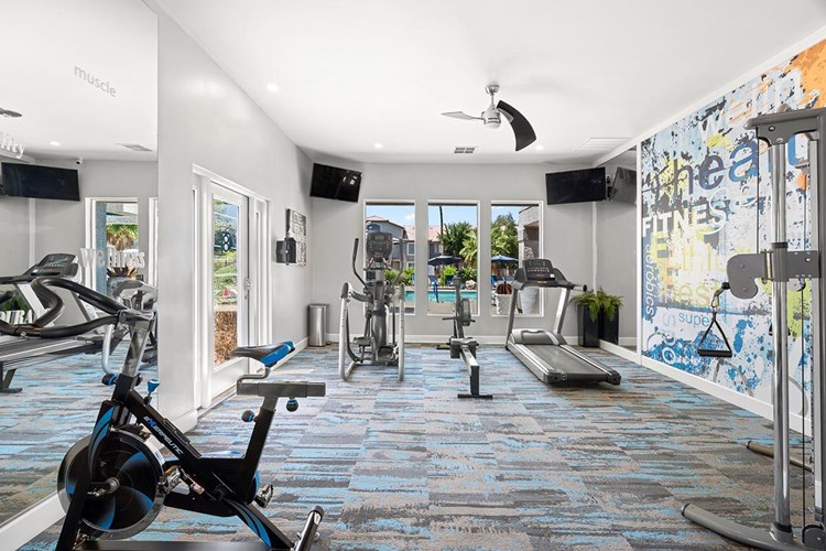 Our newly renovated fitness center features gorgeous views of the pool, state-of-the-art equipment, televisions, and free weights!