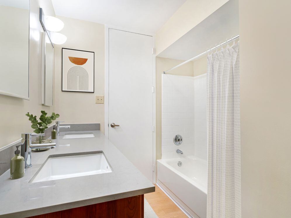 Bath with espresso cabinetry, grey quartz countertops, and hard surface flooring