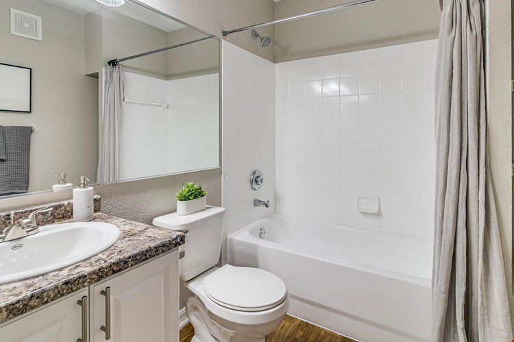 Bathrooms feature granite-style counters, wood-style flooring, and a tub/shower combination.