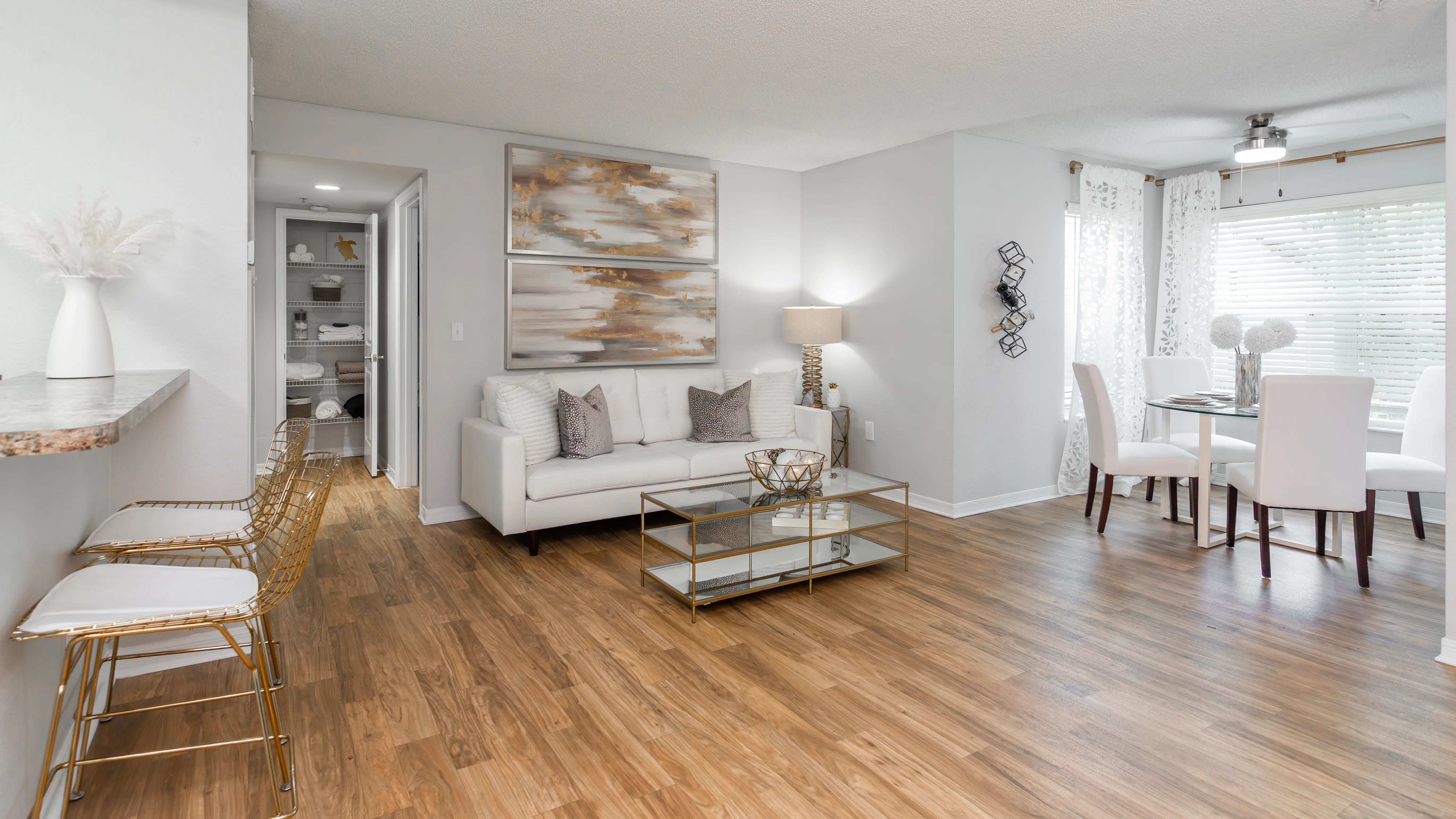 This open-concept layout features a cozy living room, sunlit dining nook, and a stylish breakfast bar.