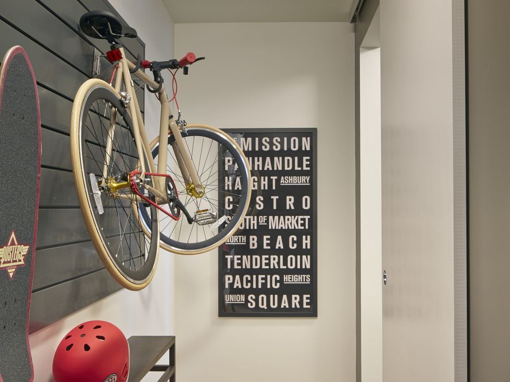 Bedroom with customizable gear wall and hard surface flooring