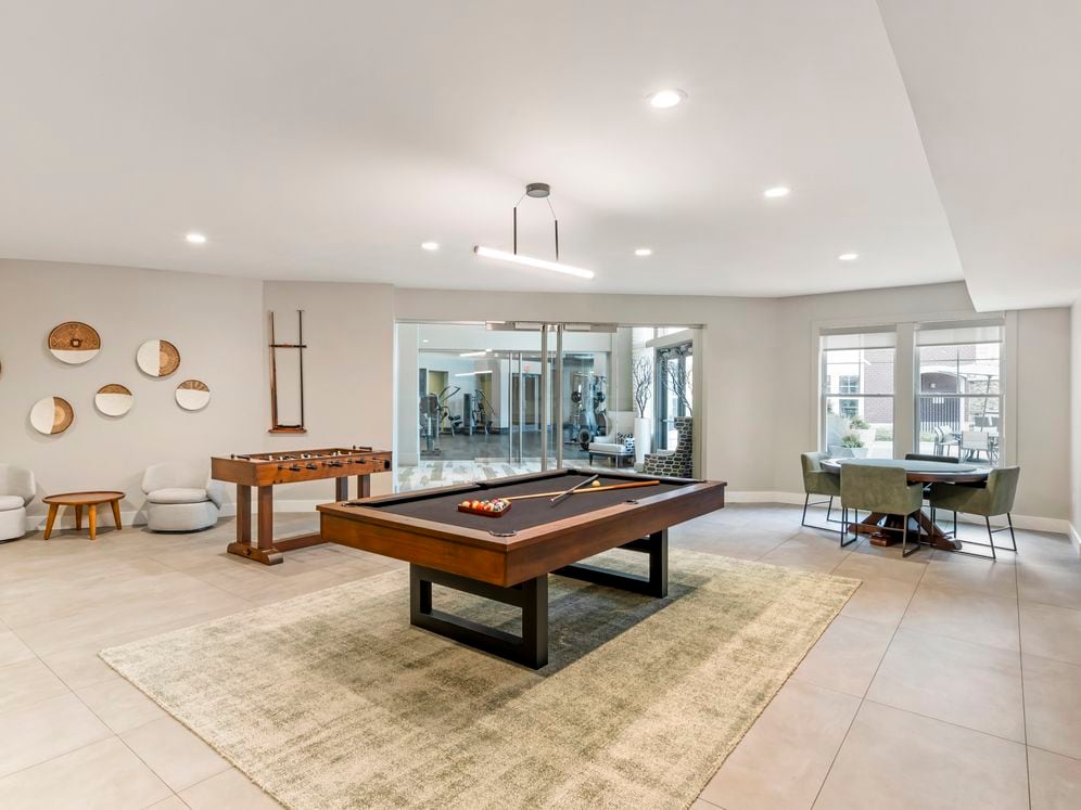 Resident lounge game room with billiards and foosball