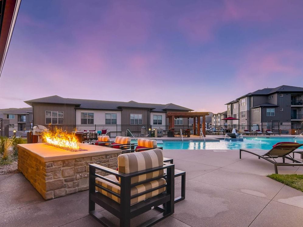 Outdoor courtyard with swimming pool, sundeck with lounge seating and fireplace