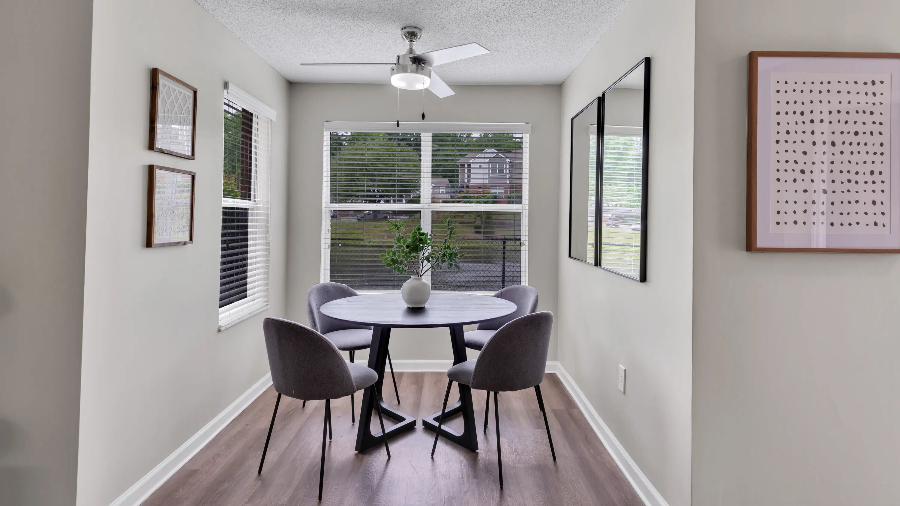 Your living room offers a solarium, a versatile haven for dining or relaxing, bathed in natural light and cooled by a breezy ceiling fan. Experience this versatile space in style. 