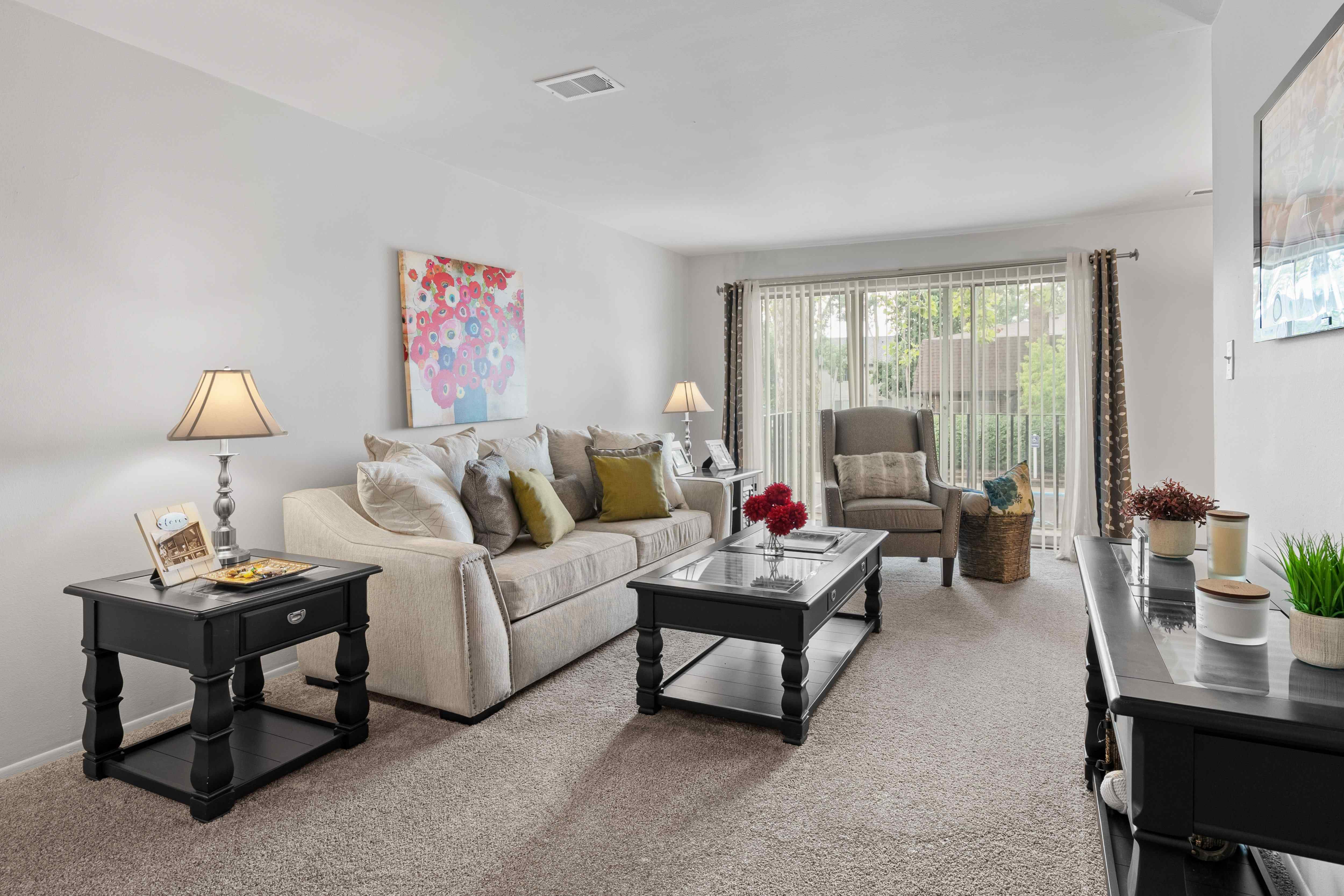 Open and airy living room with natural lighting at Knottingham Apartments in Clinton Township, MI.