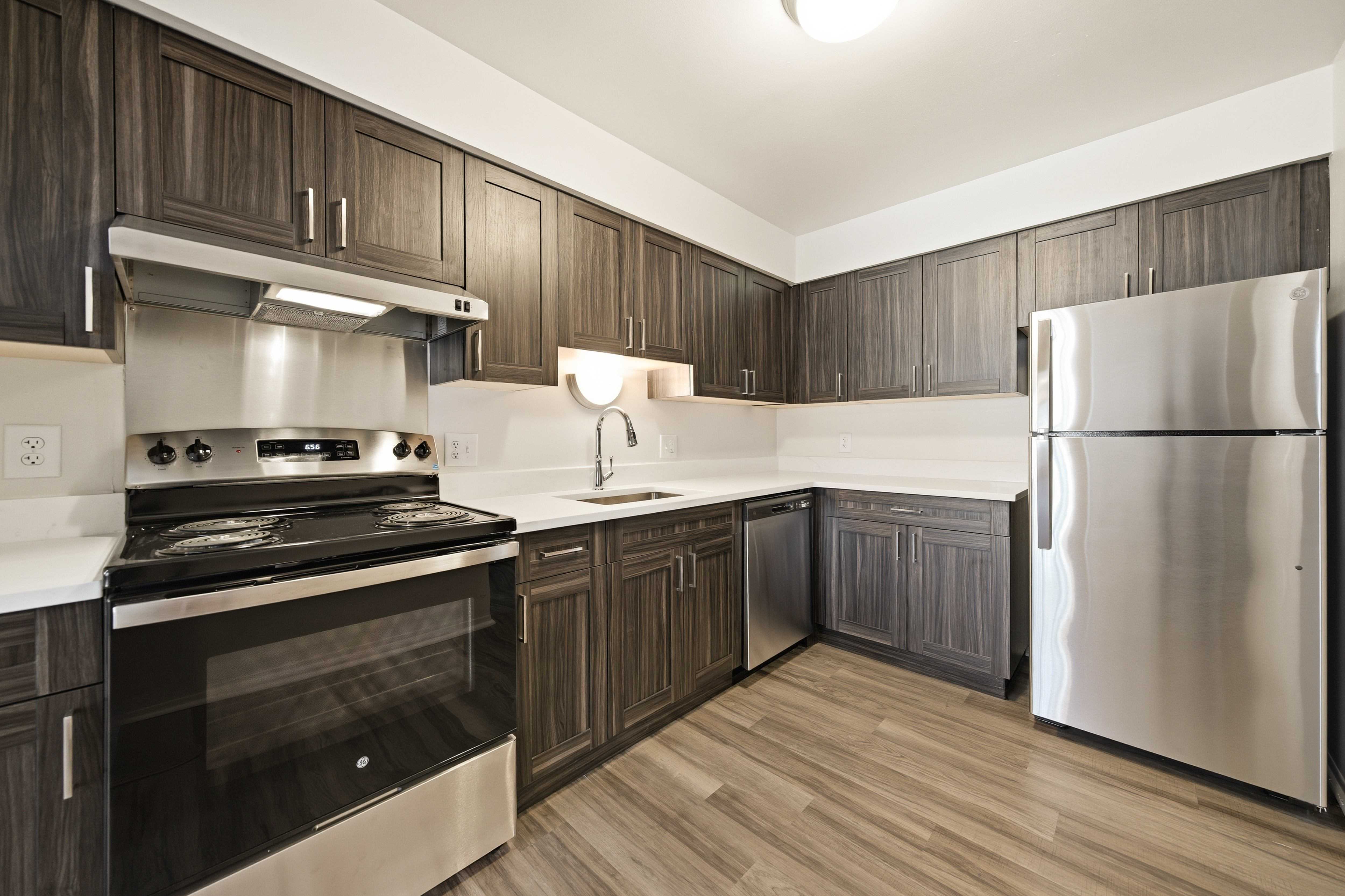 Modern kitchen with stainless steel appliances at Franklin River Apartments in Southfield, MI