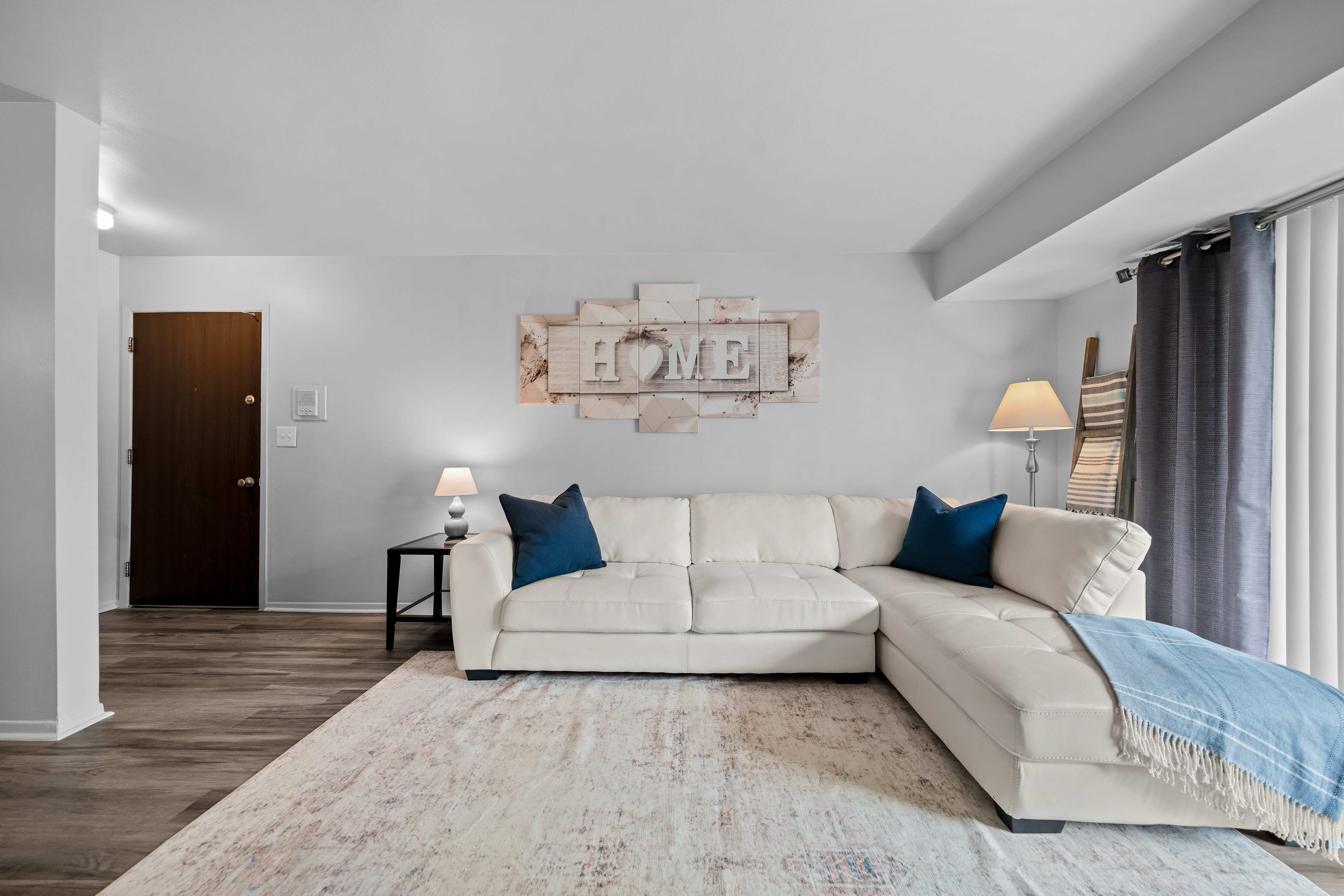 Spacious living room with natural light at Westwood Village Apartments in Westland, MI