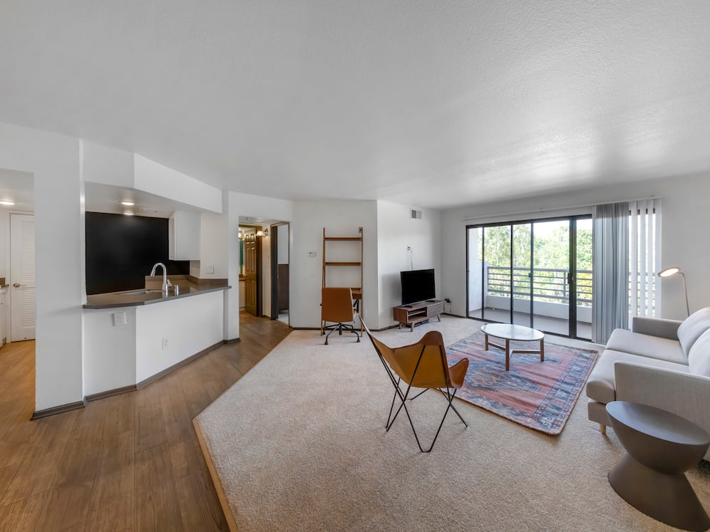 Furnished+ apartment homes come outfitted with a sofa, side chair, side table, coffee table, TV stand and 50" Television (Representative Image – exact items and style of furnishings may vary)