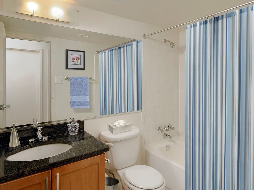 Bathroom with granite countertop and tile flooring