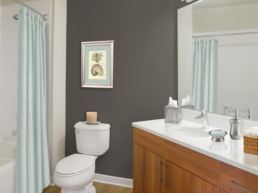 Upgraded bath with walnut cabinetry, white quartz countertop and hard surface flooring