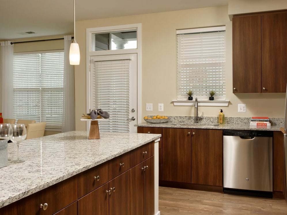Kitchen with granite countertops, cherry cabinetry, stainless steel appliances and hard surface flooring