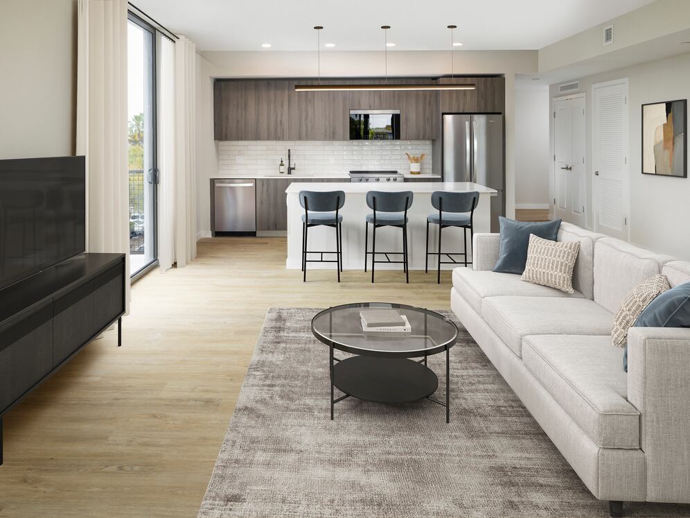 Upgrade Collection II Three-bedroom apartment kitchen with espresso cabinetry, white tile backsplash, white quartz countertop, and hard-surface vinyl plank flooring