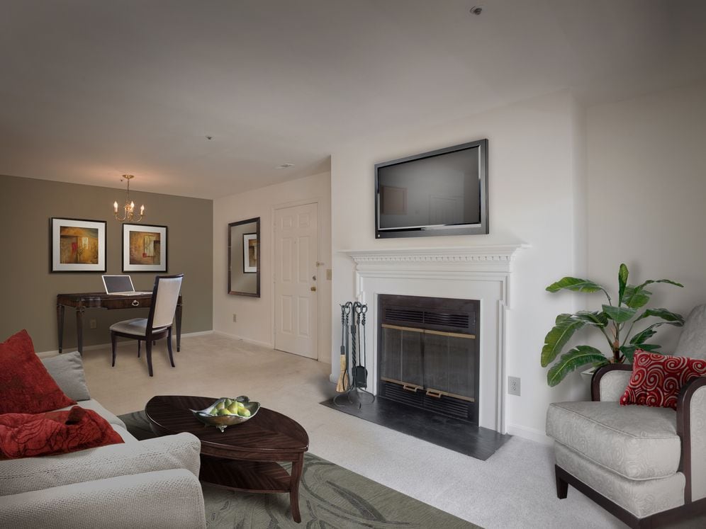 Carpeted living area with fireplace