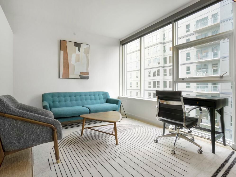 Furnished+ apartment homes come outfitted with a sofa, side chair, side table, coffee table, office desk, office chair, and TV stand and 50" Television (Representative Image – exact items and style of furnishings may vary)