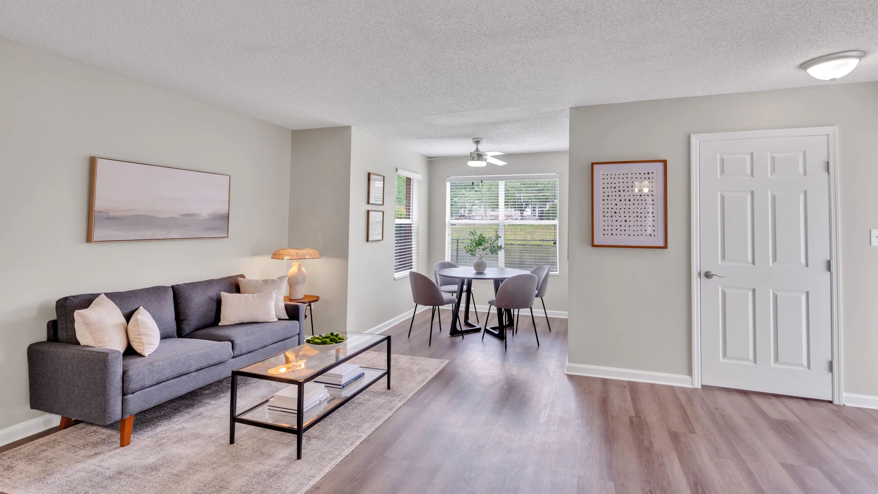 Experience the graceful transition from living room to dining area, complete with an inviting ceiling fan. A symphony of grace and space unfolds. 