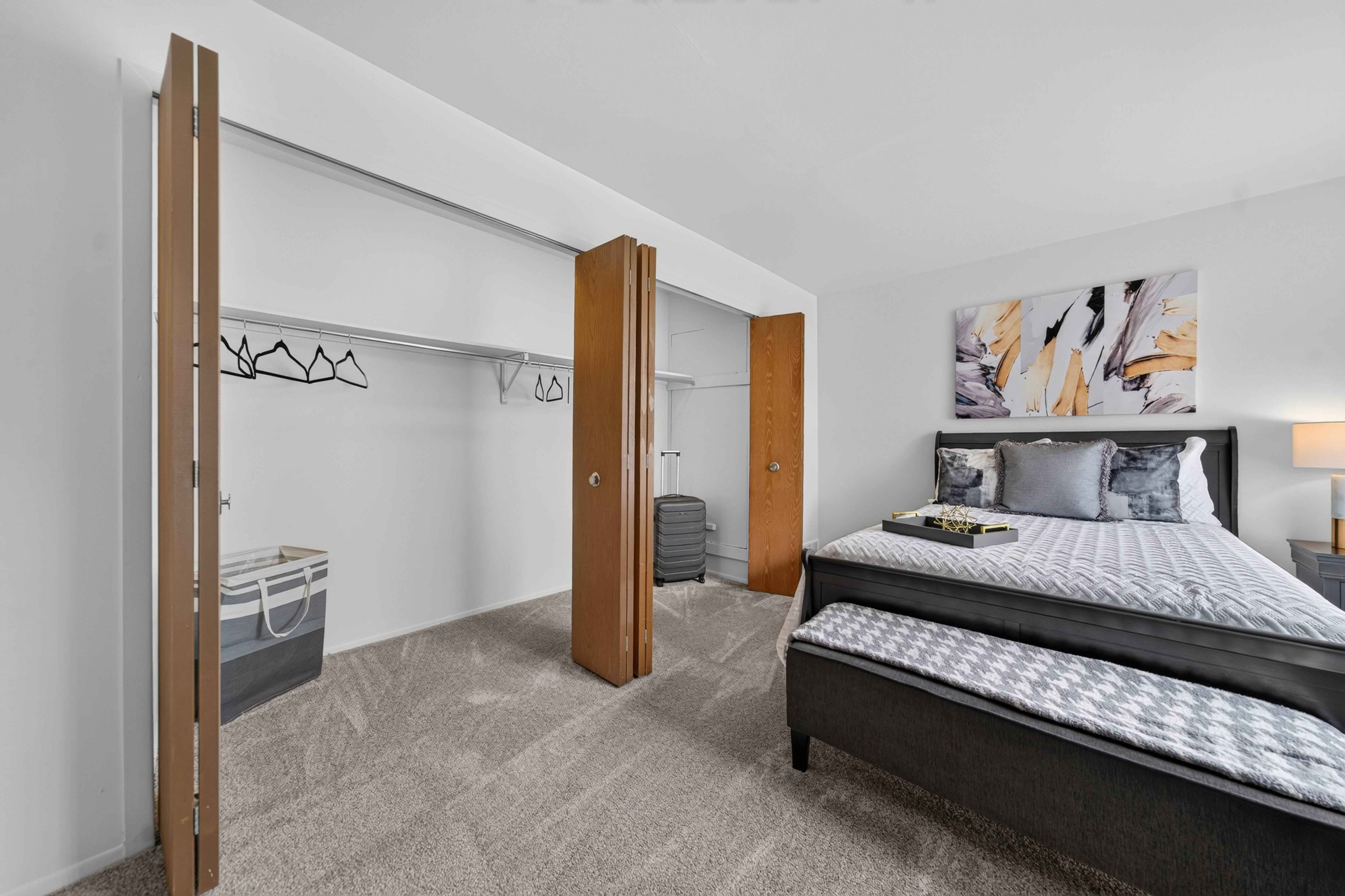 Bedroom with ample storage space at Franklin River Apartments in Southfield, MI.