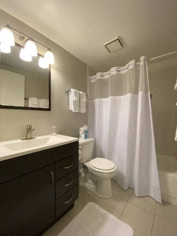 Bathroom with vanity storage and a full tub