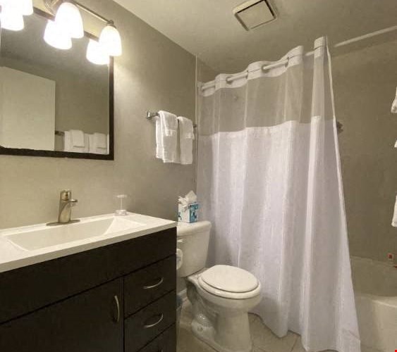 Bathroom with vanity storage and a full tub