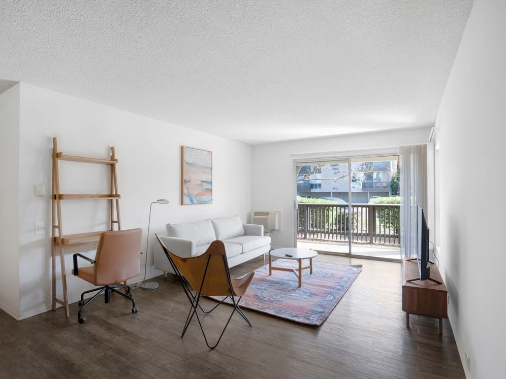 Furnished+ apartment homes come outfitted with a sofa, side chair, side table, coffee table, TV stand and 50" Television (Representative Image – exact items and style of furnishings may vary)