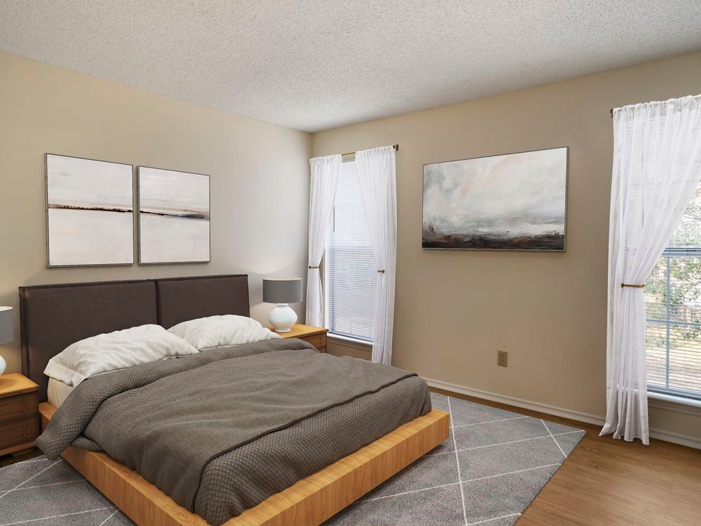 Renovated Package I bedroom featuring hard surface flooring in select units