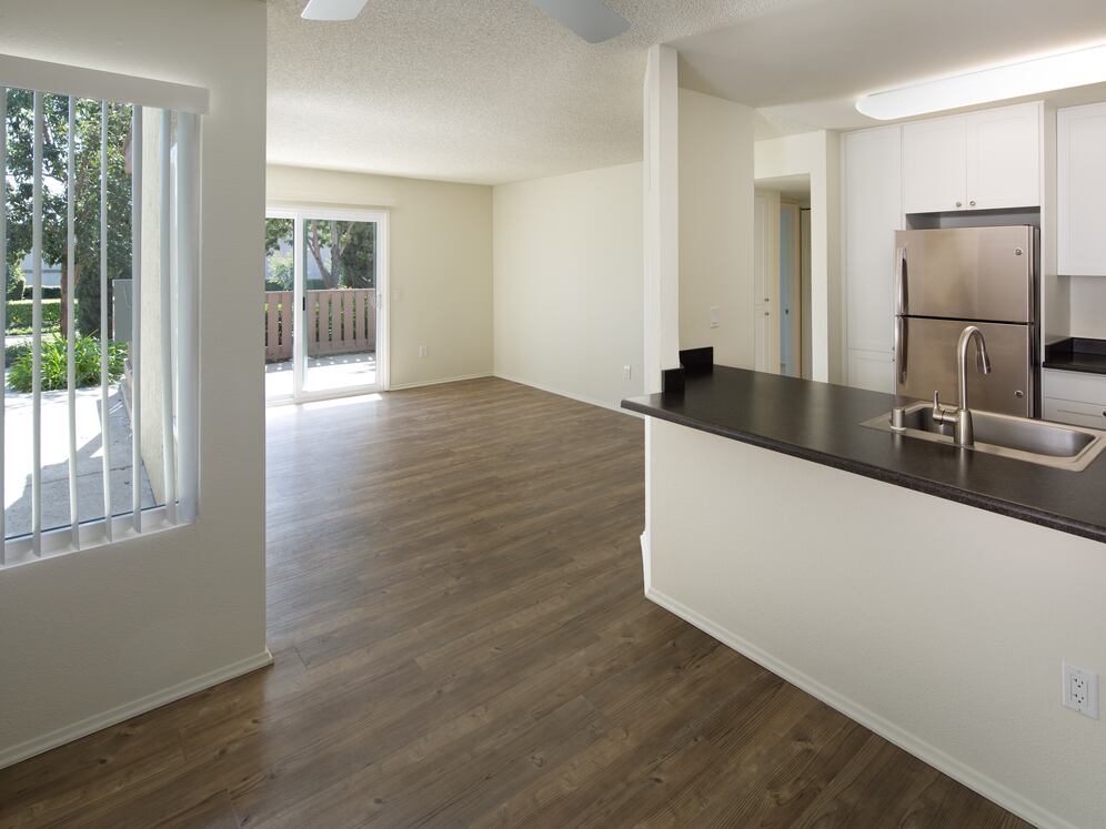 Renovated Package I kitchen, dining, and living area with hard-surface flooring