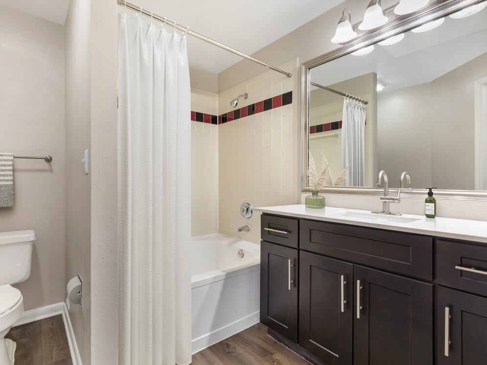 Classic Package I bath with white quartz countertop, espresso cabinetry, and hard surface flooring