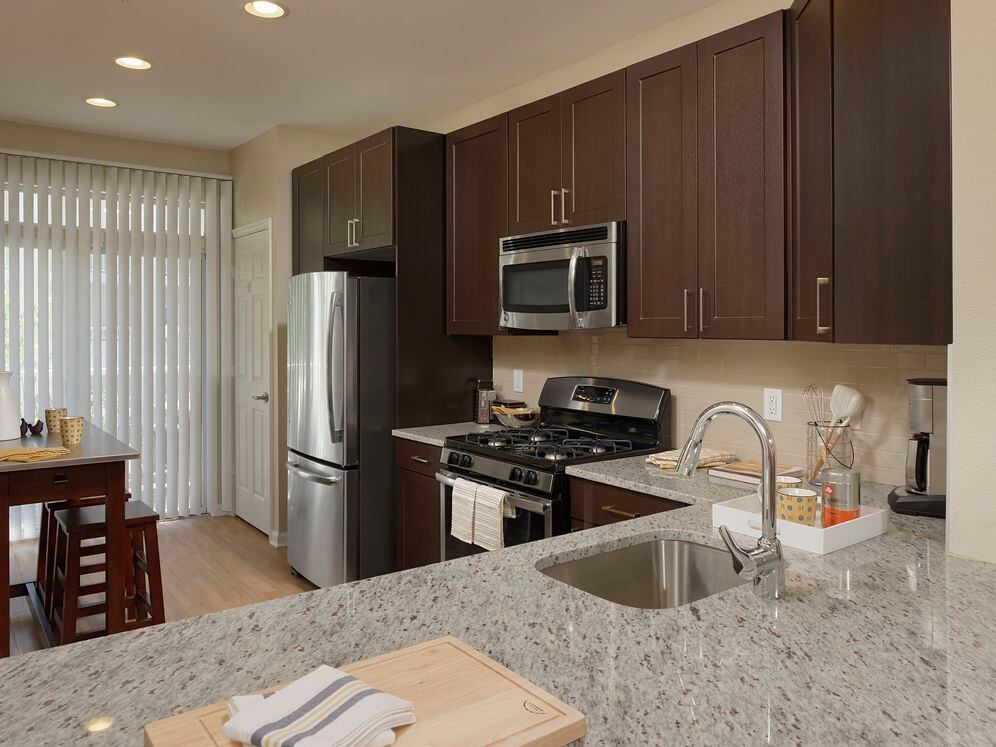 Espresso Finish Package kitchen with granite countertops, stainless steel appliances and hard surface flooring