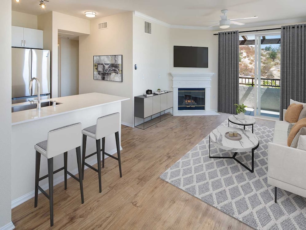 Renovated Package I kitchen and living room area with open concept floor plan, fireplace, and hard surface flooring