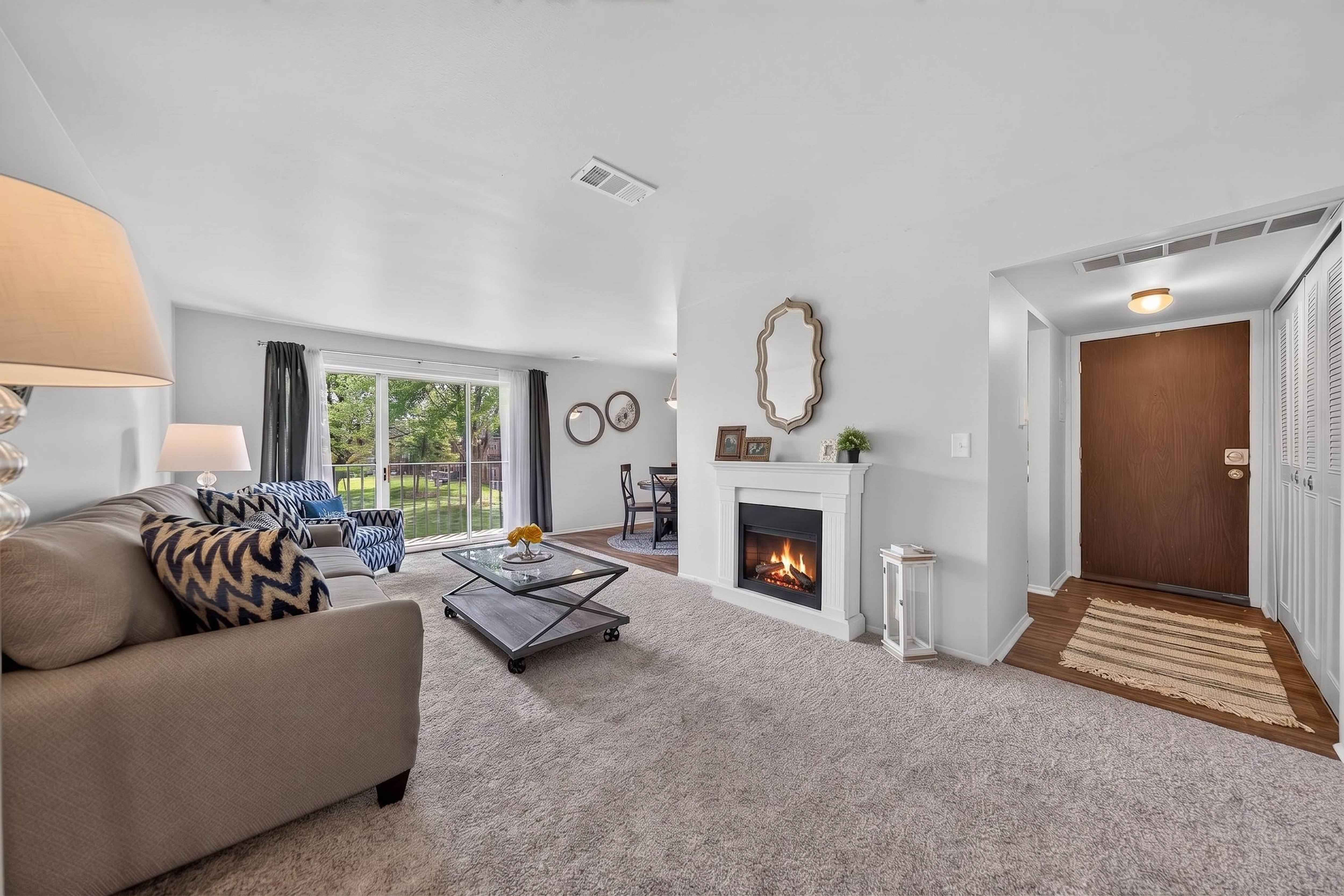 Elevated living room with a private balcony at Drawbridge Apartments in Harrison Township, MI.