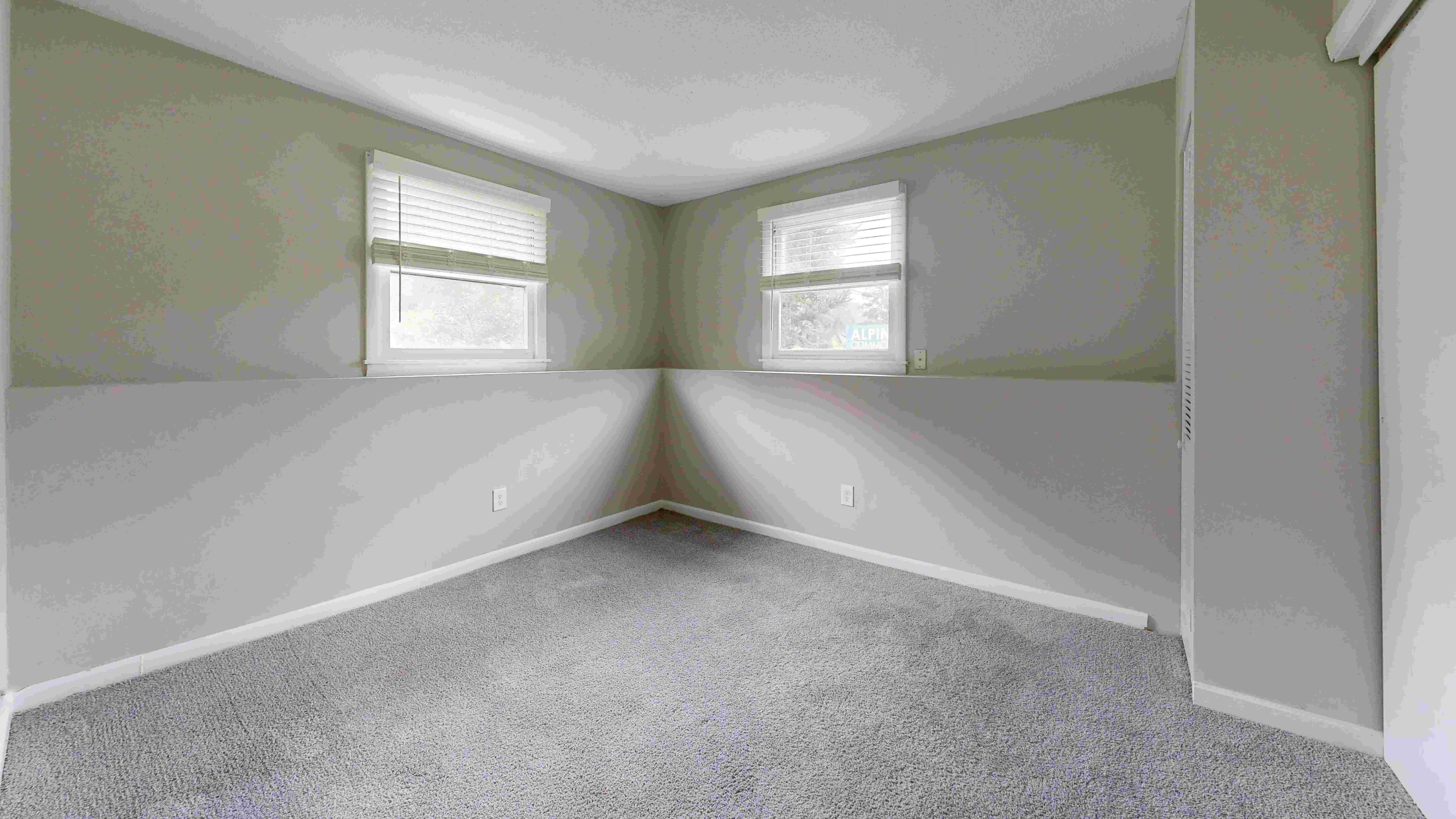 Discover the bright and airy bedroom in The Valley floor plan featuring large windows for natural light.