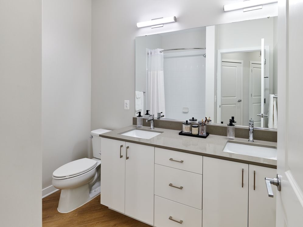 Design Collection II bath with white cabinetry, grey quartz countertops, and hard surface flooring