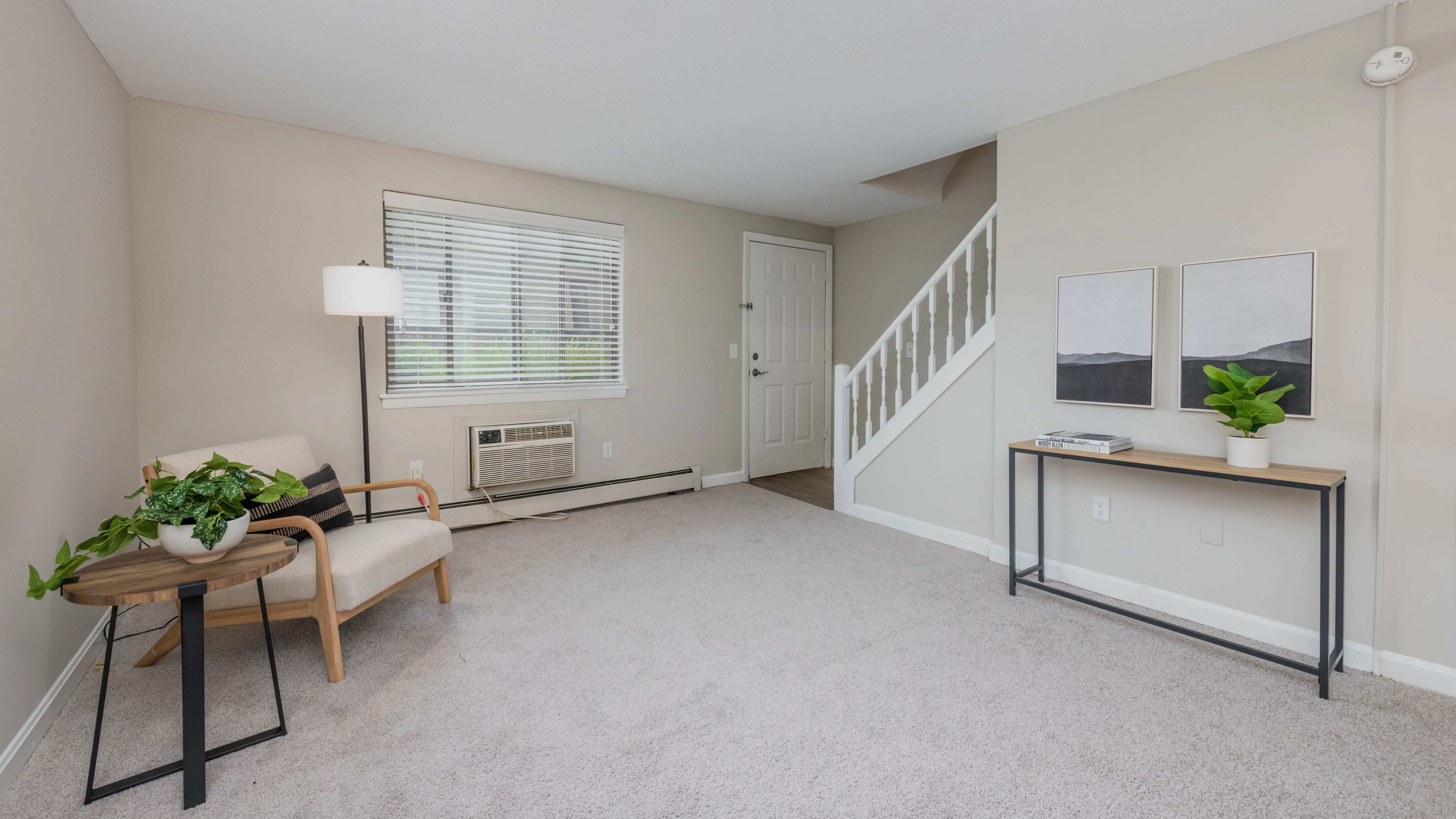 Discover townhome bliss in The Sycamore, with a roomy living room, plush carpeting, and a bright, airy ambiance.