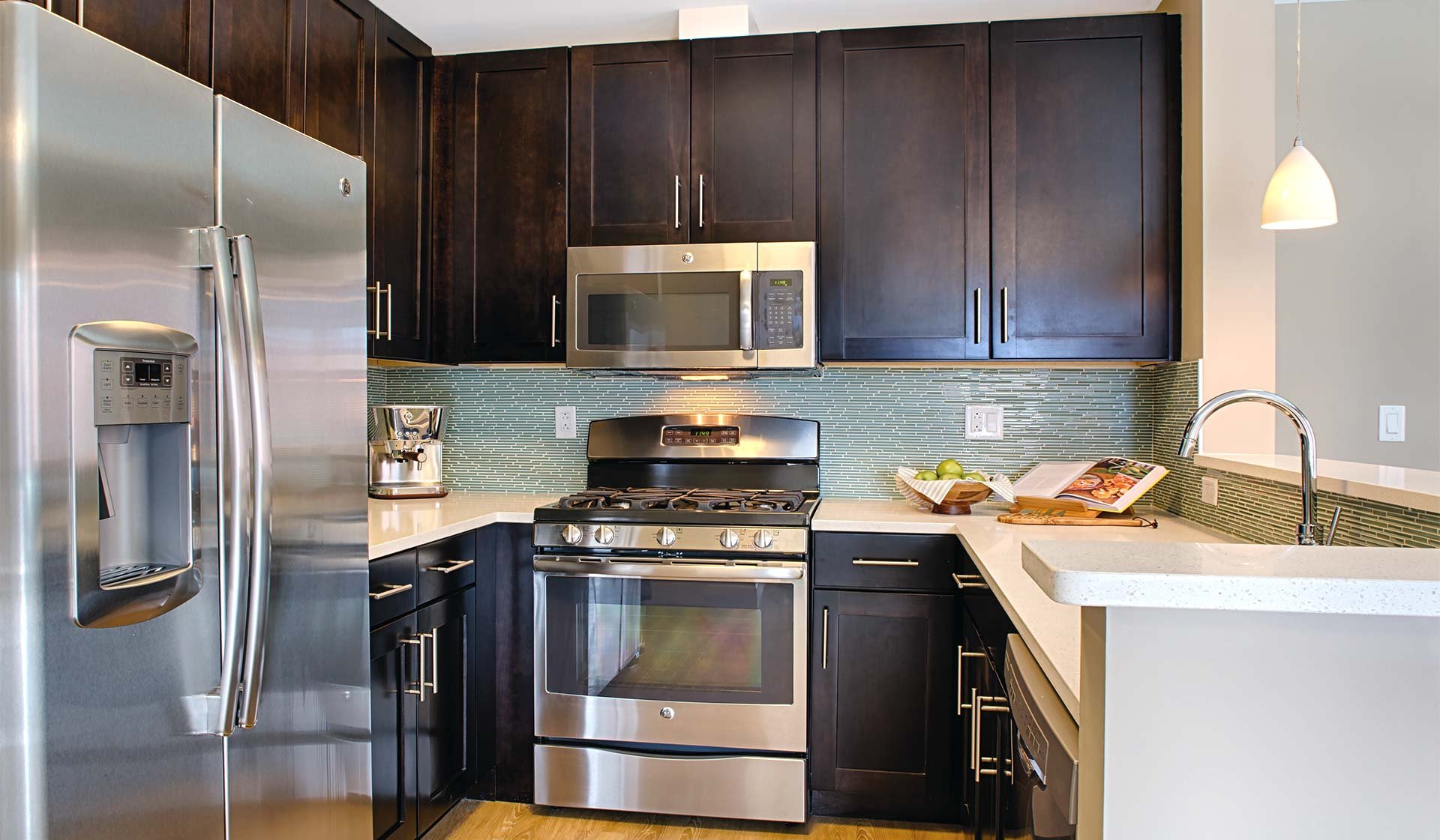 Kitchens feature stainless steel appliances, quartz countertops, and espresso cabinets