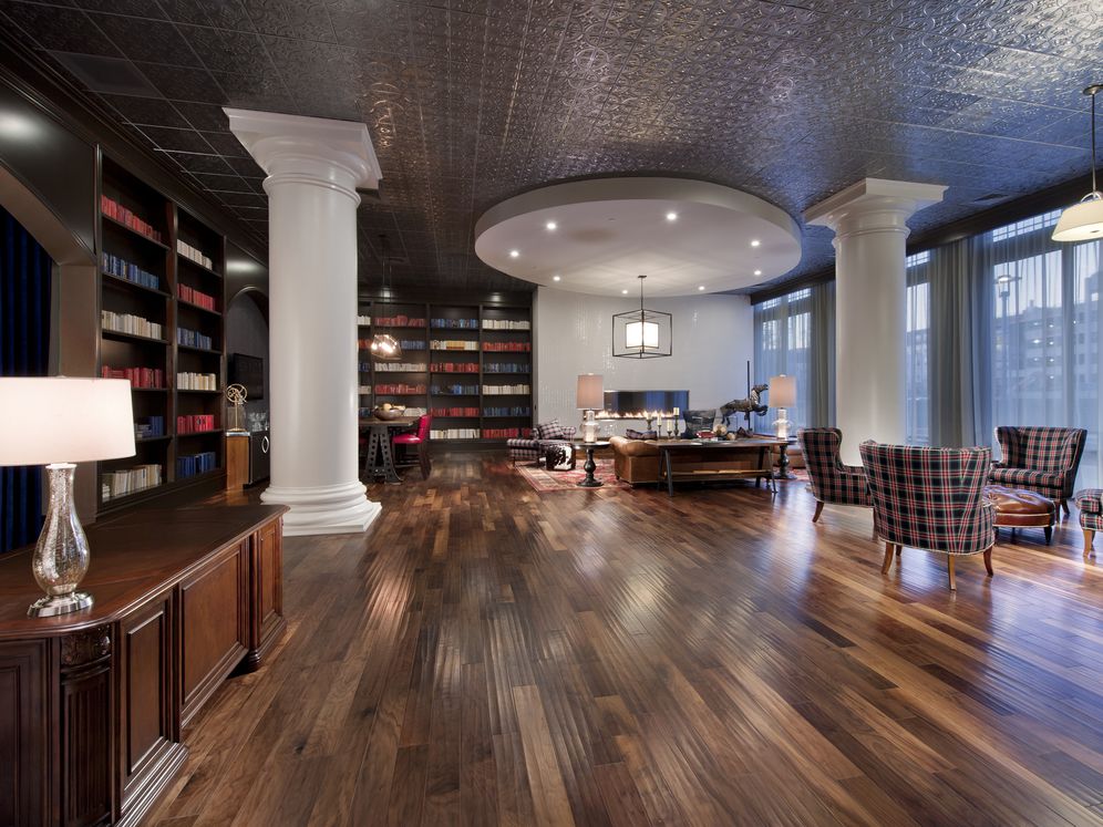 Resident lounge library room with fireplaces and seating