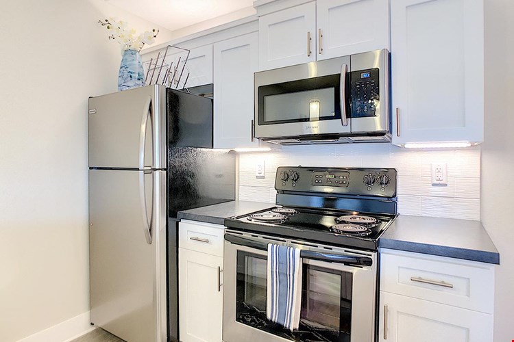 Kitchens feature stainless steel appliances.