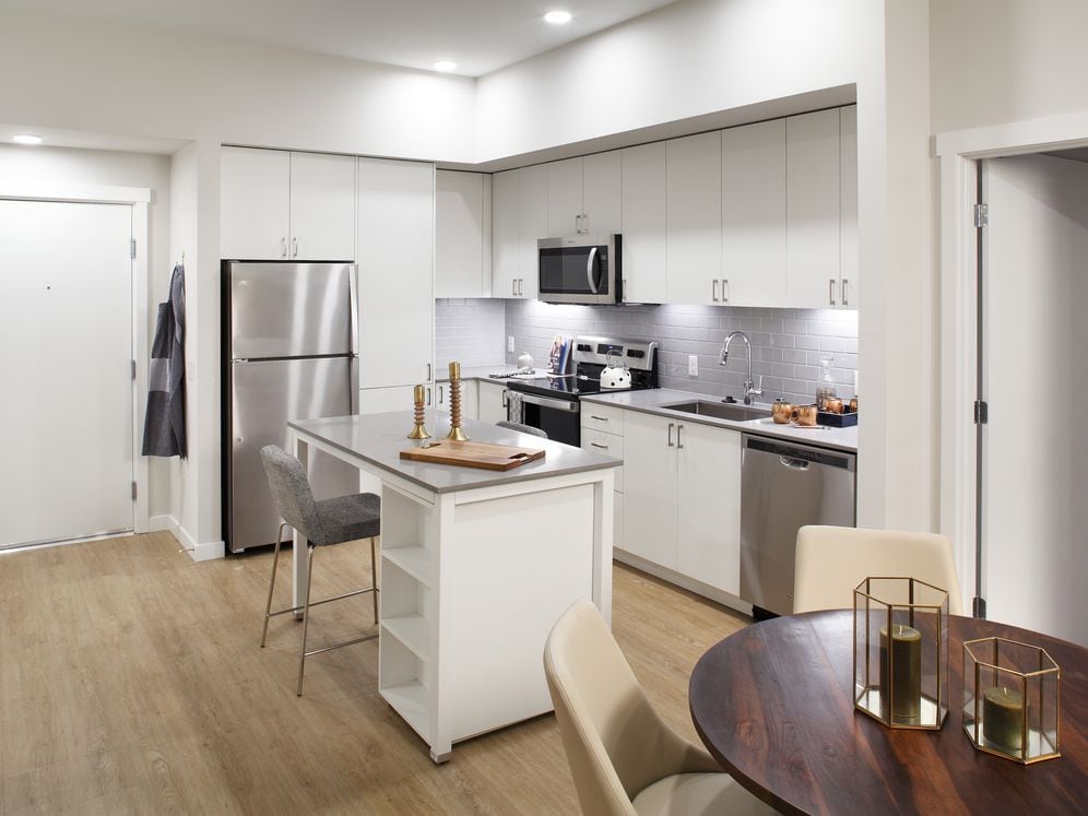 Phase II - Scheme C Kitchen with white cabinetry, grey tile backsplash, and stainless steel appliances
