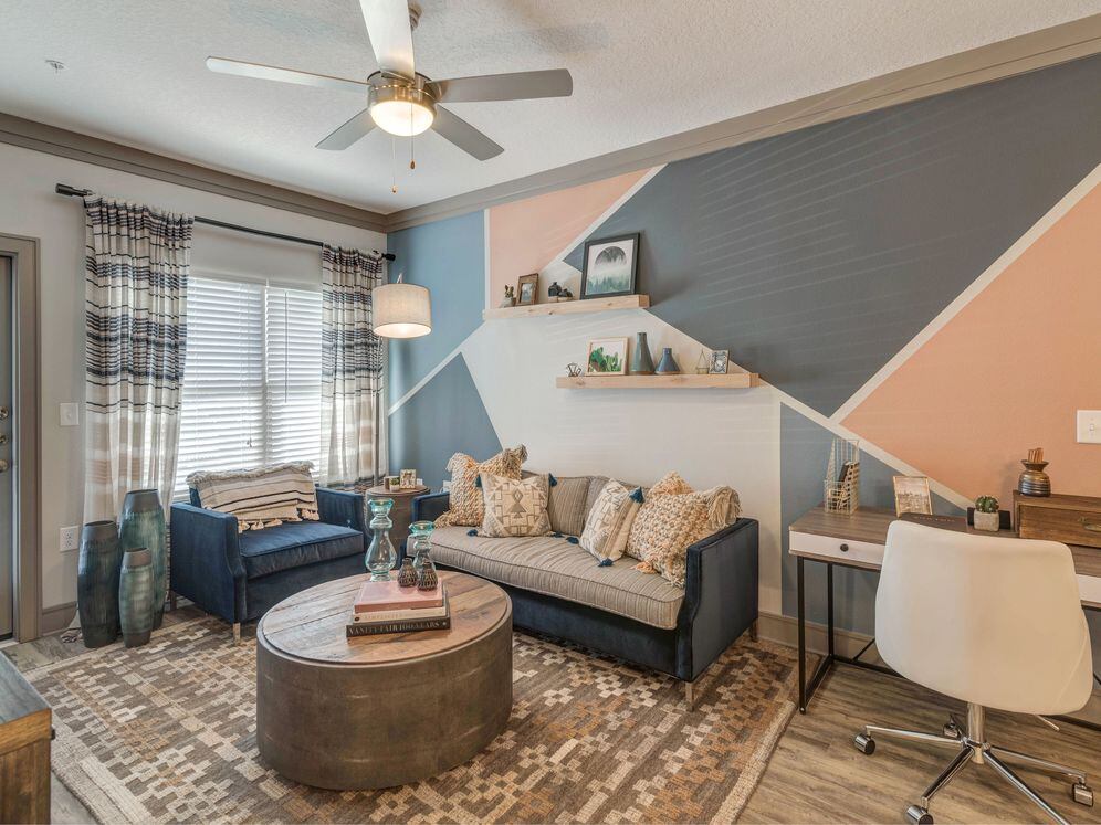 Living room with hard-surface flooring and ceiling fan