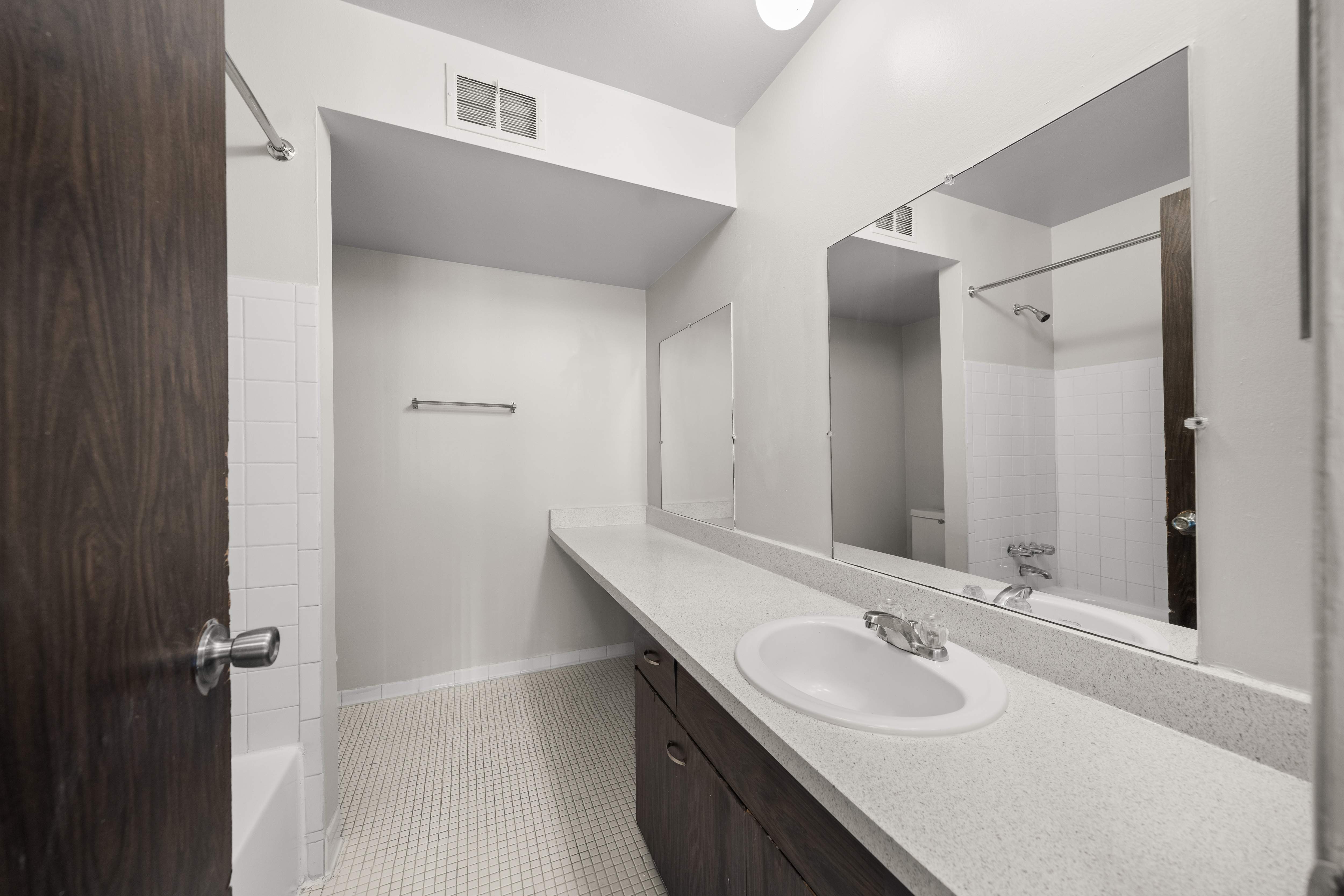 Elevated bathroom with ample storage space at Knottingham Apartments in Clinton Township, MI.