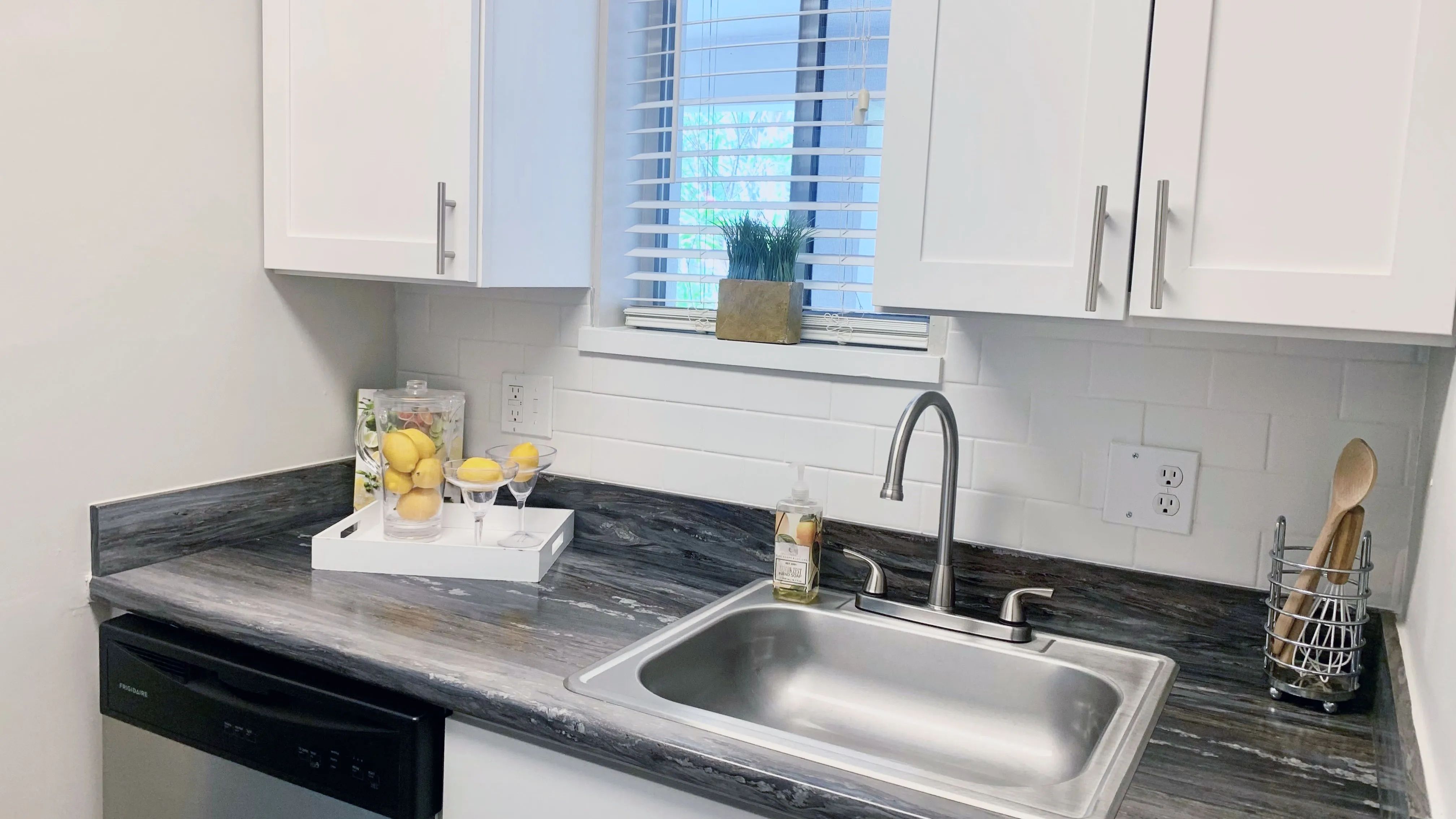 Enjoy an elegant studio kitchen with stainless-steel appliances, including a dishwasher, for inspired living with convenience and charm. 